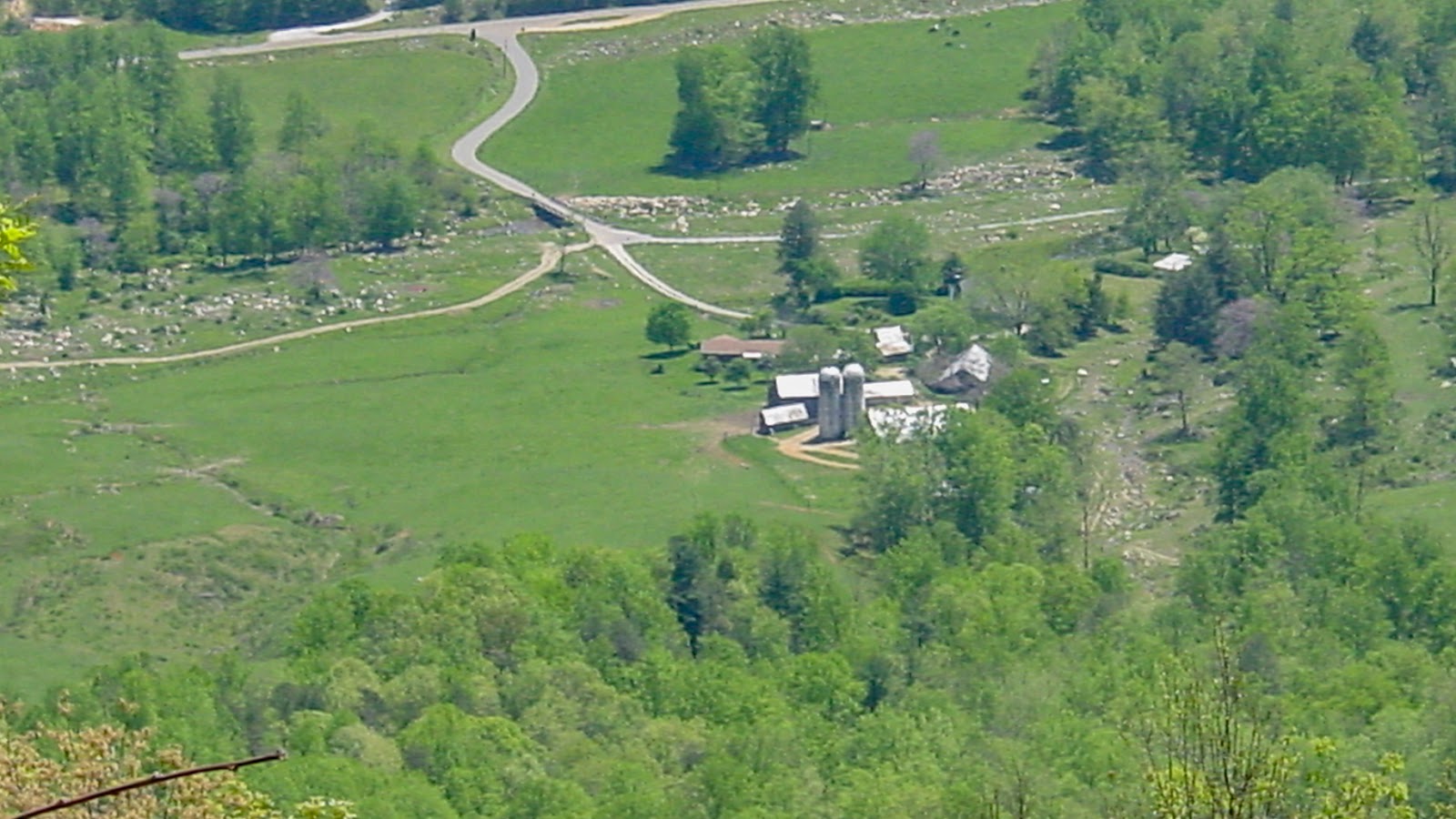 A farm and cleared land from above. 