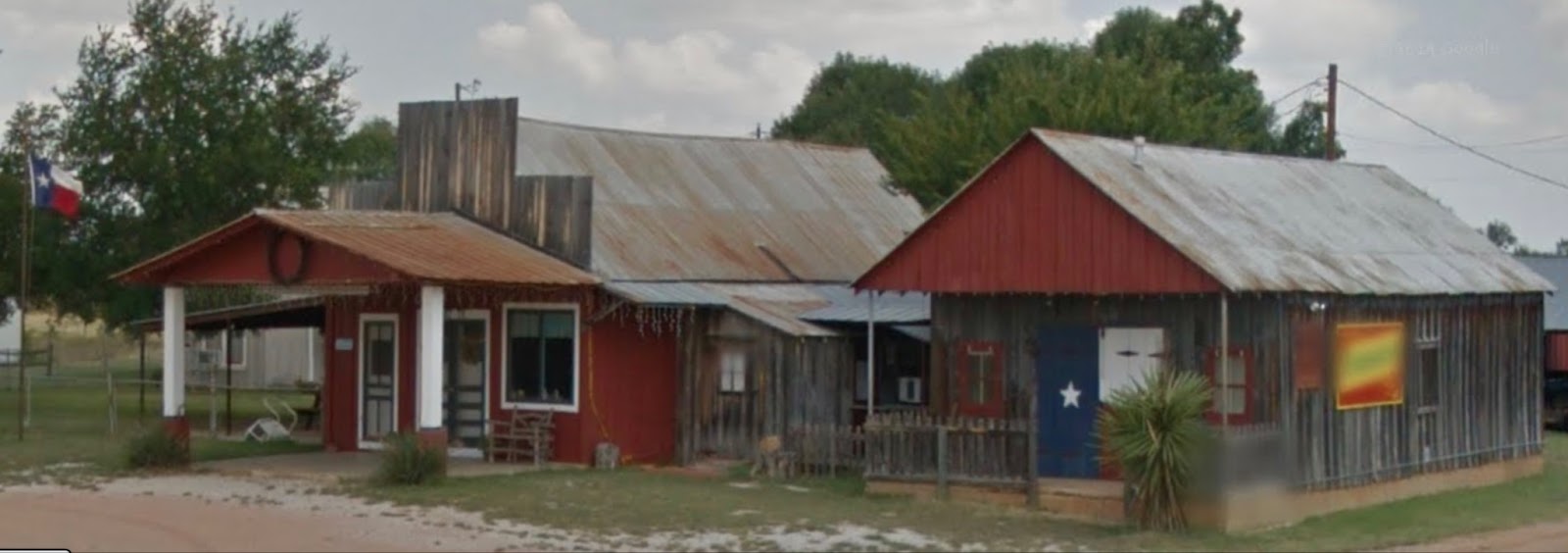 An unused and rusted metal roofed building. 