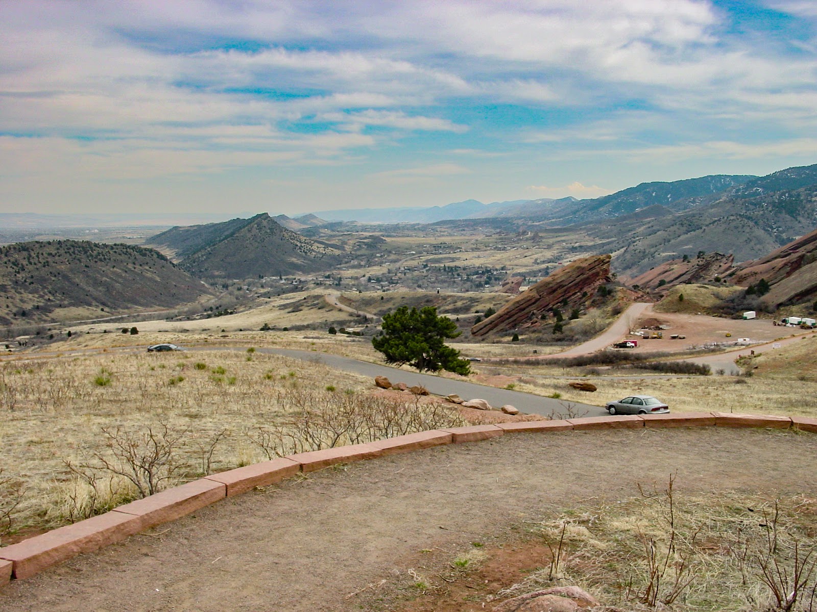 Contoured land with a road and homes.