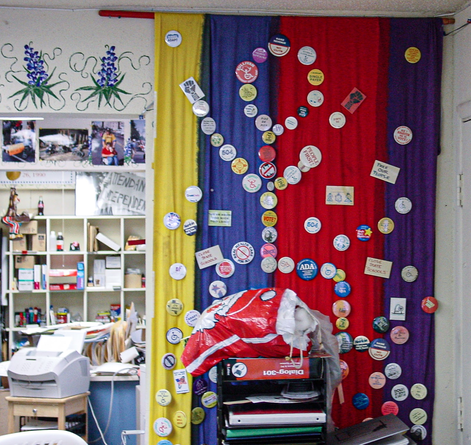 Stick man made out of buttons decorate a colorful wall.