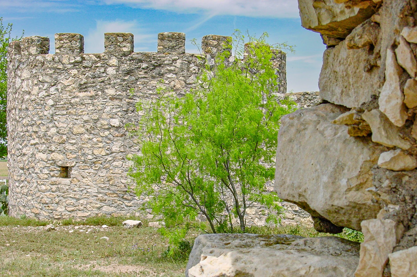 The ruins of an old fieldstone structure with an cylindrical turret.
