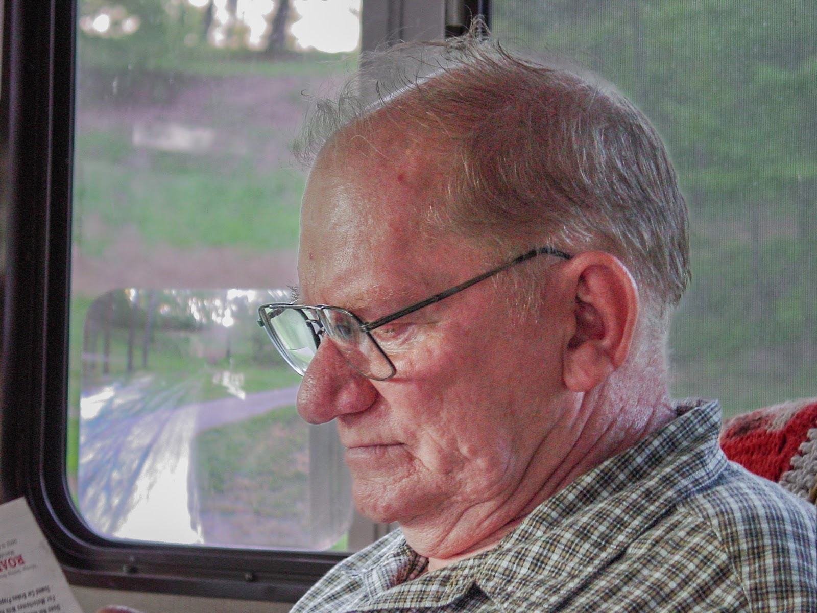 Man in RV reads a magazine. 
