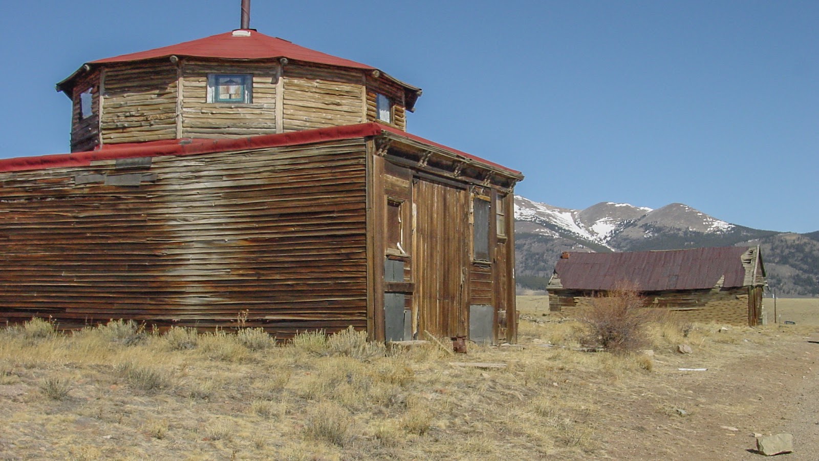 Wooden barn with octagon turret second floor.