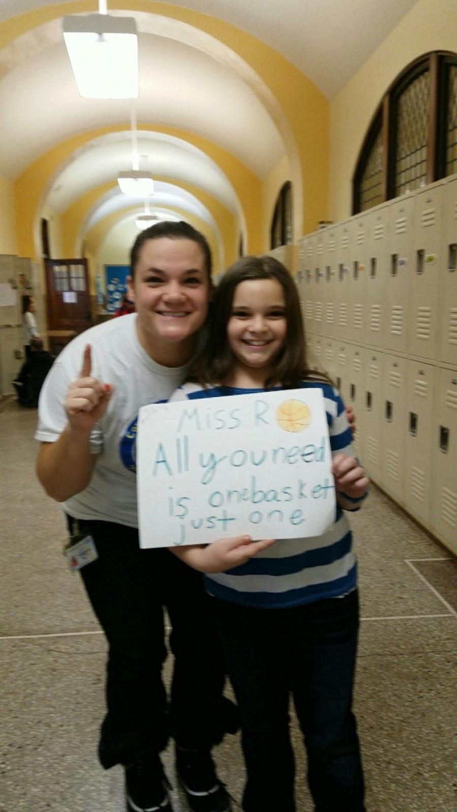 A person and person holding a sign

Description automatically generated with medium confidence