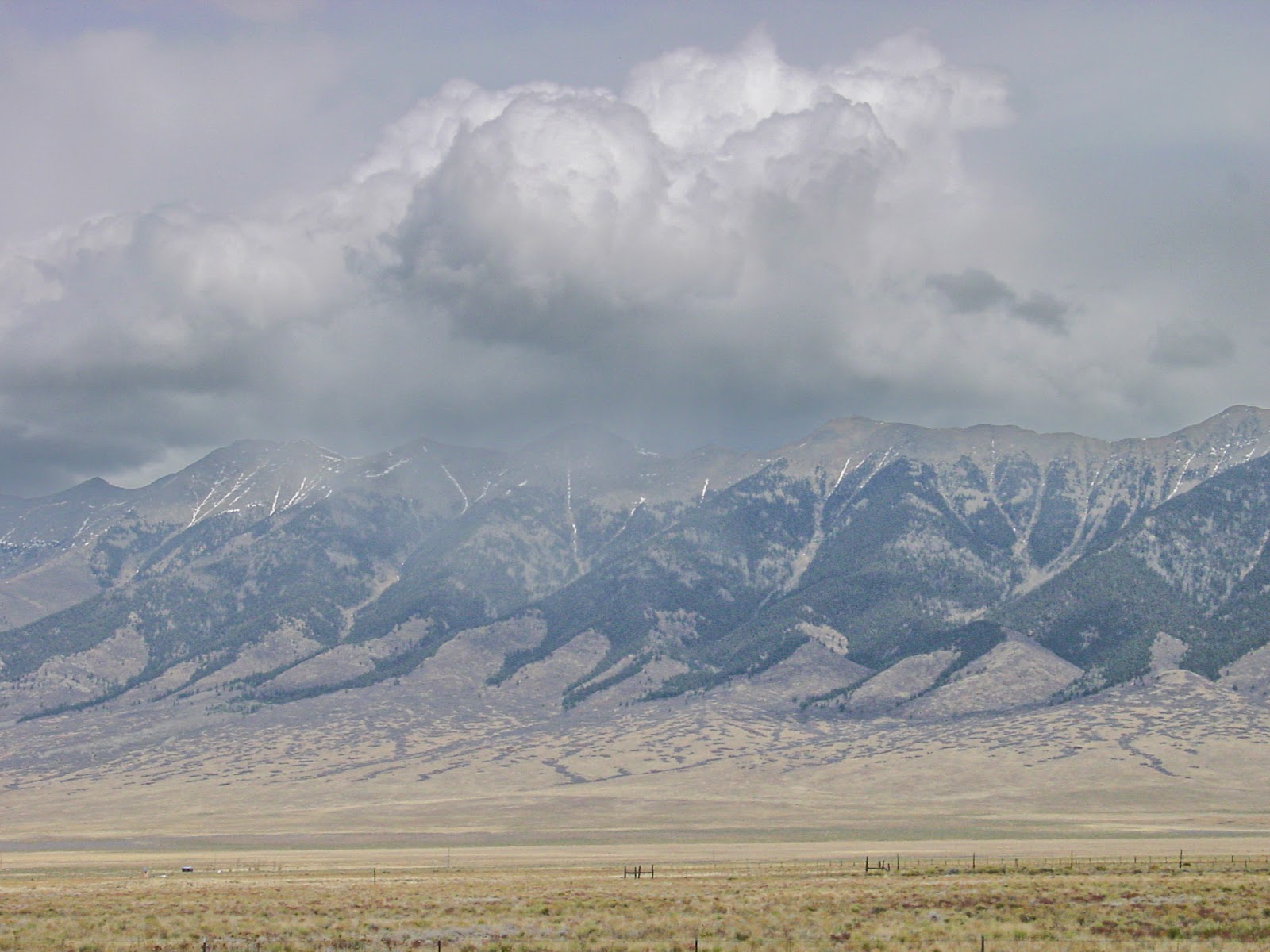 Tall mountain tops are obscured in the clouds. 
