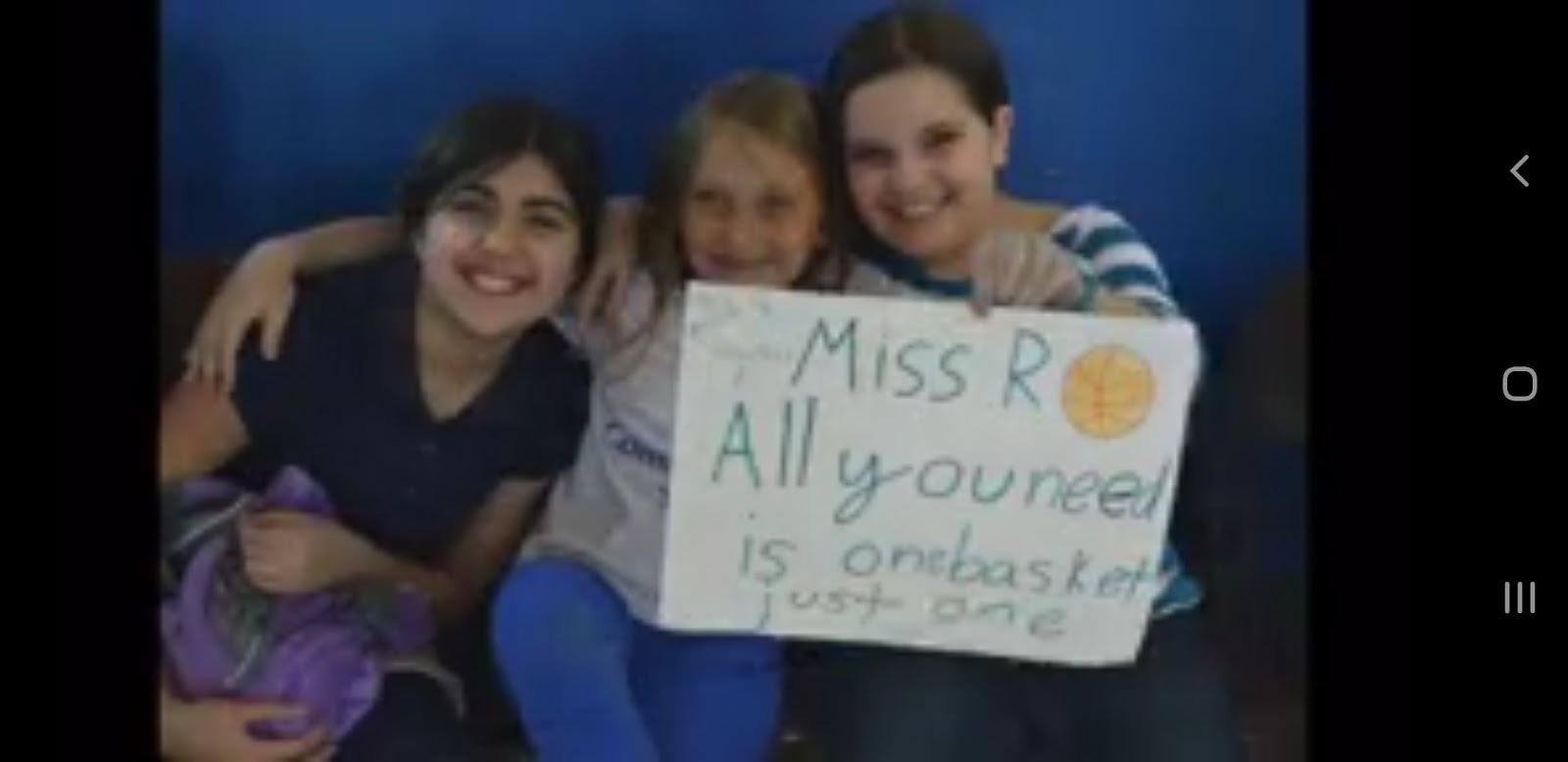 A group of people holding a sign

Description automatically generated