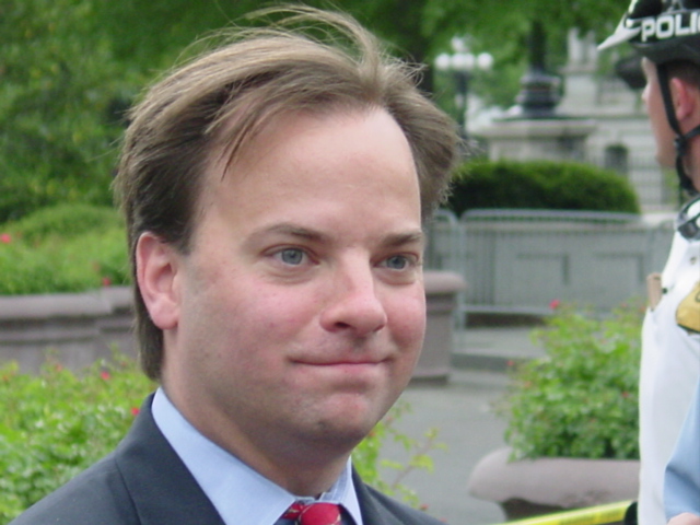 Young man in a blue suit and red tie. 