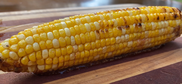 grilled corn on a wooden table