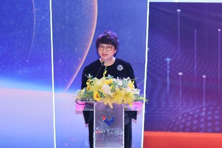 A person standing at a podium with flowers