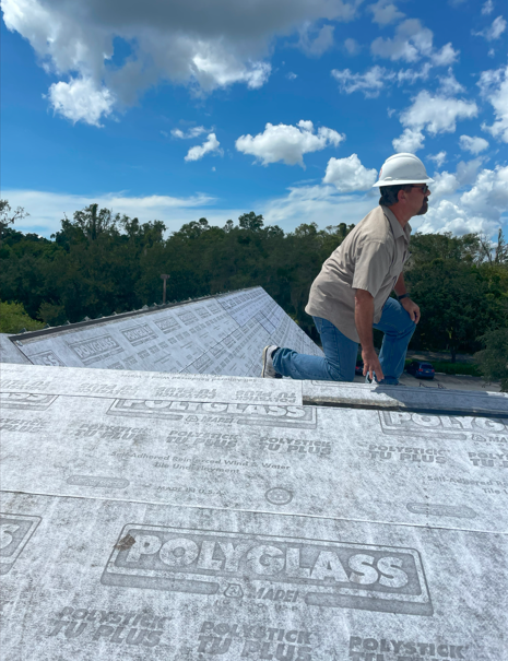 Roofer on top of residential home roof 