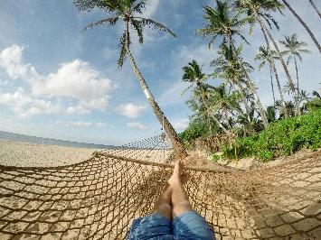 A person lying in a hammock on a beach

AI-generated content may be incorrect.