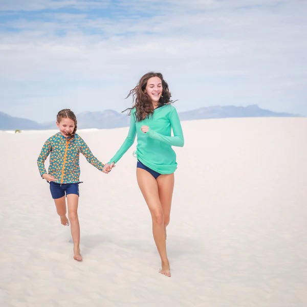 Girls in SwimZip rash guard sets at the beach—How to find modest swimwear for tweens