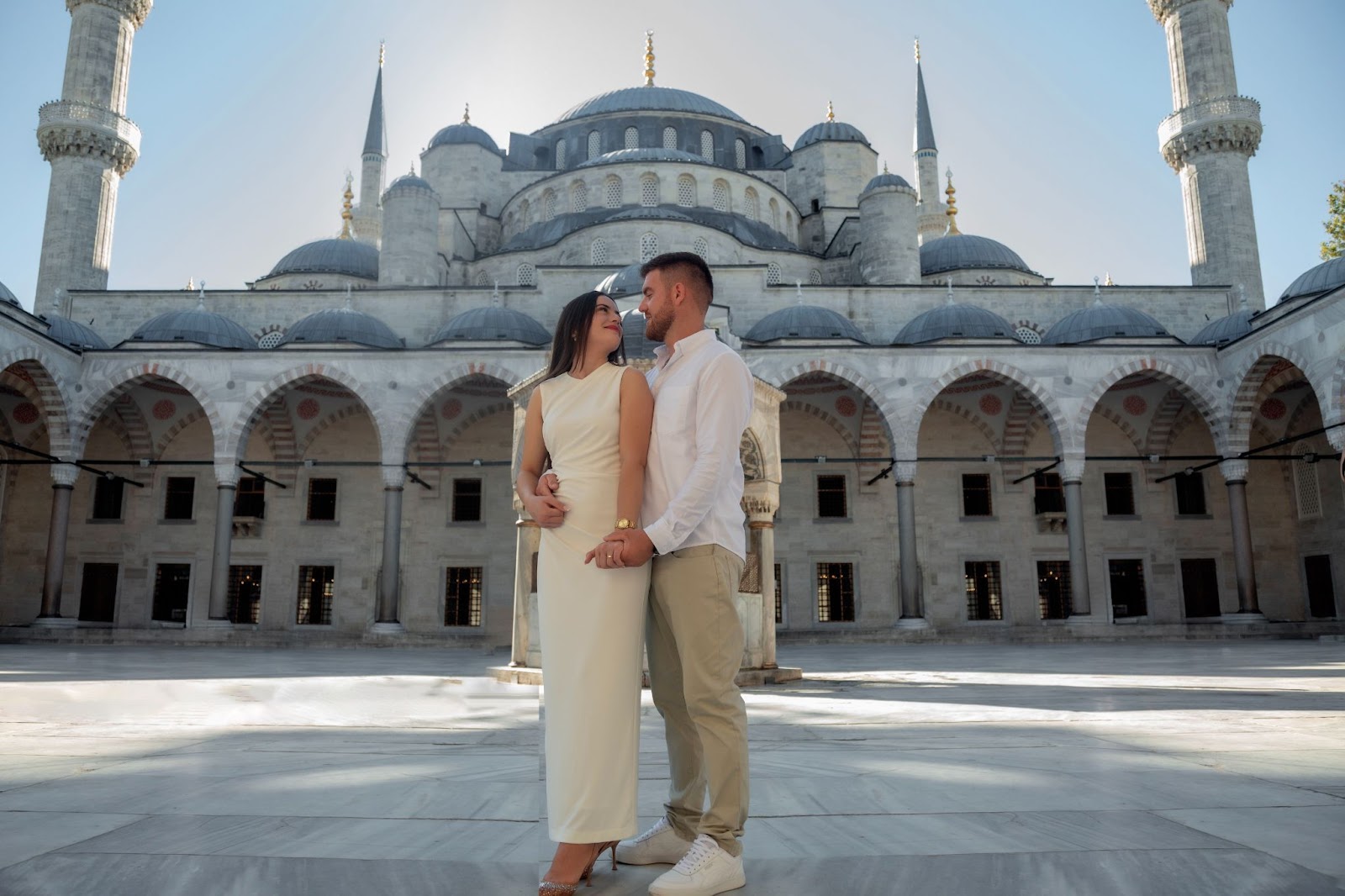 Couple at Blue Mosque courtyard, dressed for the moment.
