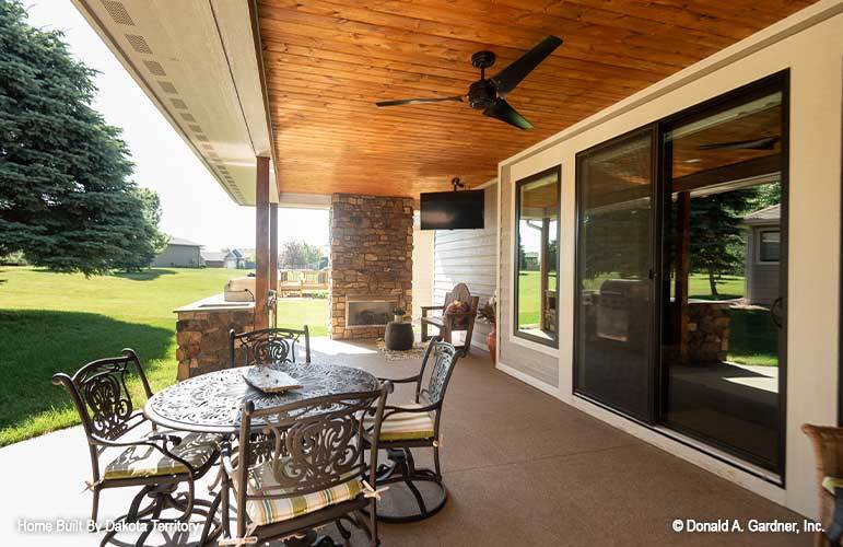 It includes an ornate metal dining set situated just off the sliding doors.