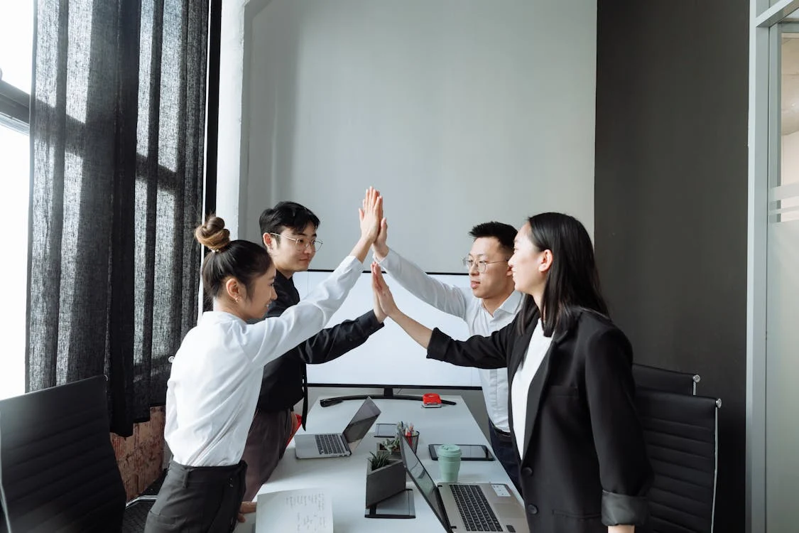 An hr team giving high fives
