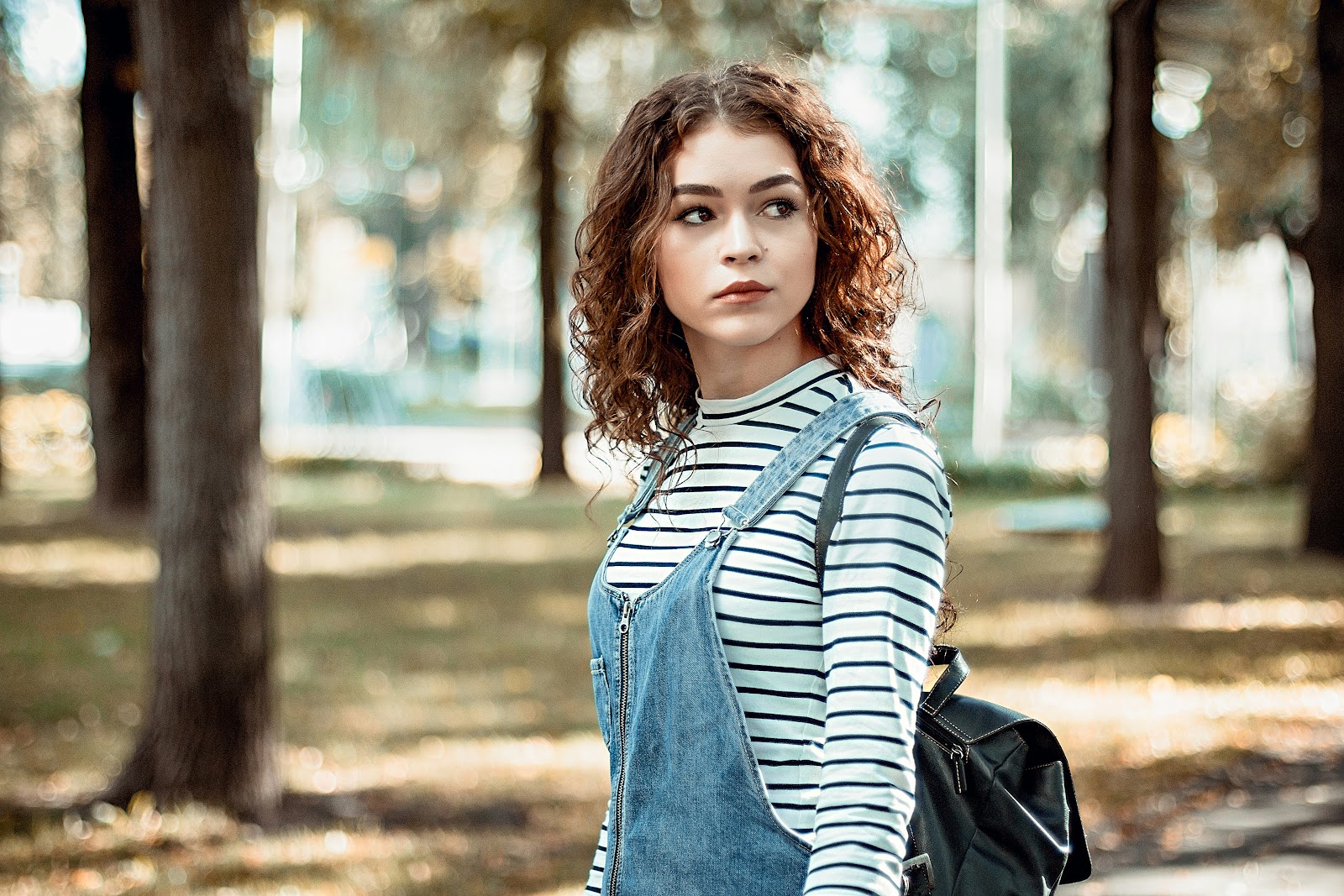 A woman for a professional headshot in outdoor lighting