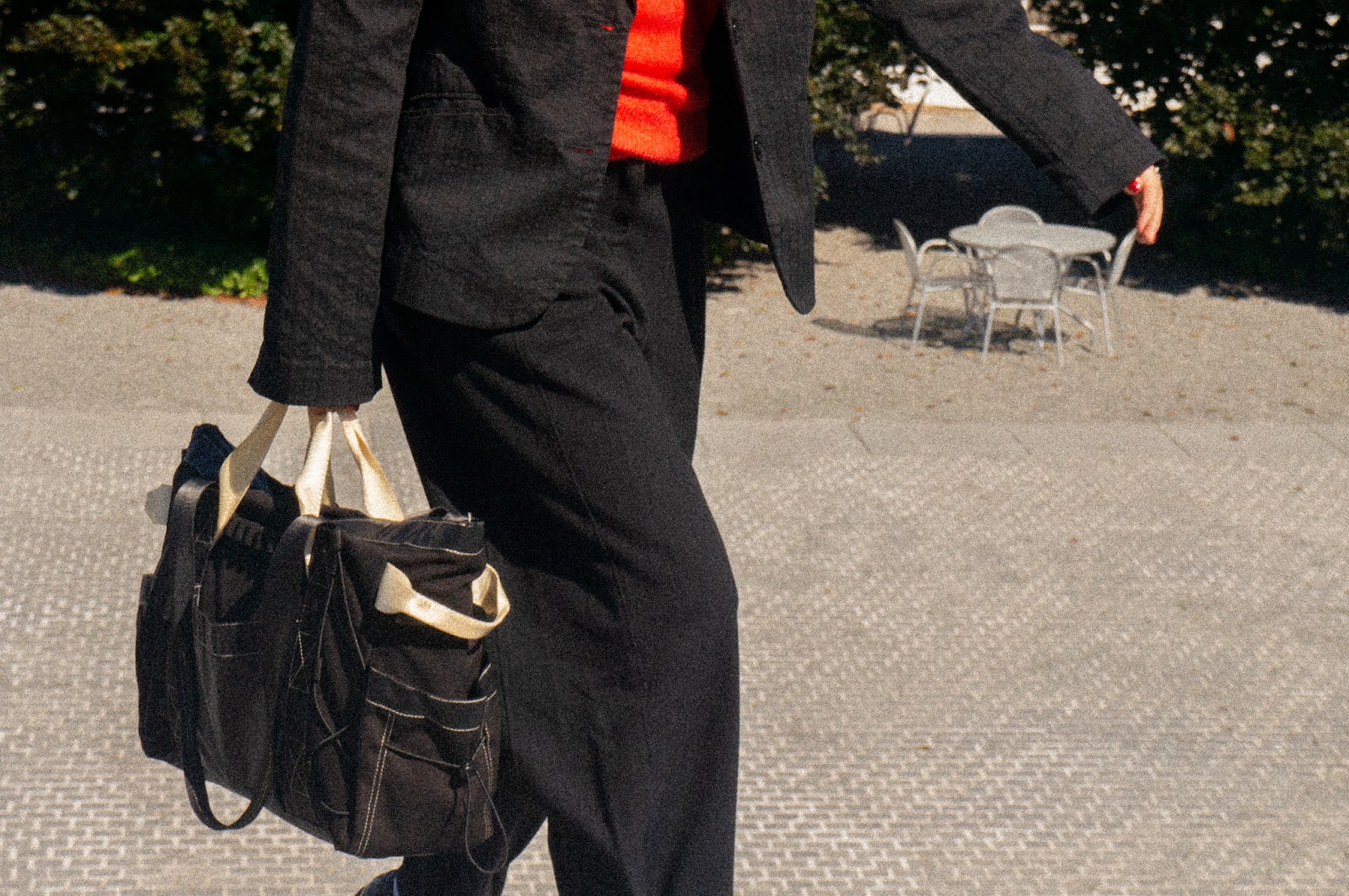 Person in business attire walking with FHD Utility Tote.