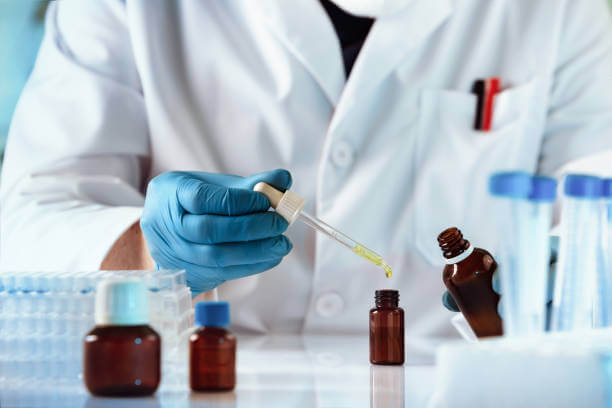 A pharmacist in a white coat carefully preparing a customized rosacea treatment in a lab.