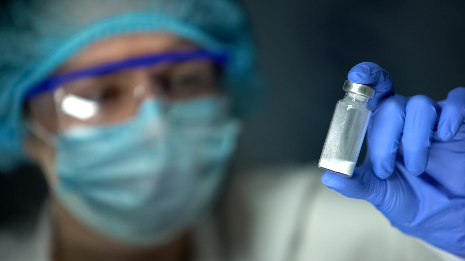 a-scientist-in-protective-gear-holding-a-vial-of-white-powder-substance-in-a-laboratory-setting-the-ovagen-blackout-why-this-bioregulator-is-kept-off-the-radar-tony-huge