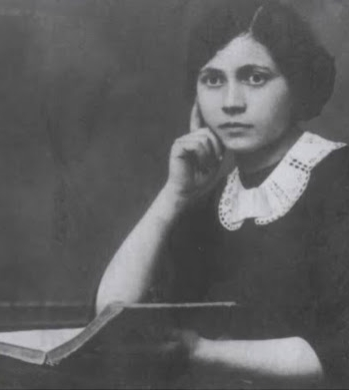 ּBlack and white photo of a young woman with a book, looking pensive