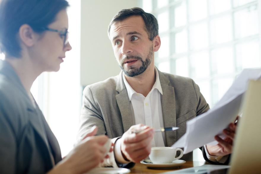 A tax professional talking to the client about the possible steps for filing an Offer in Compromise.