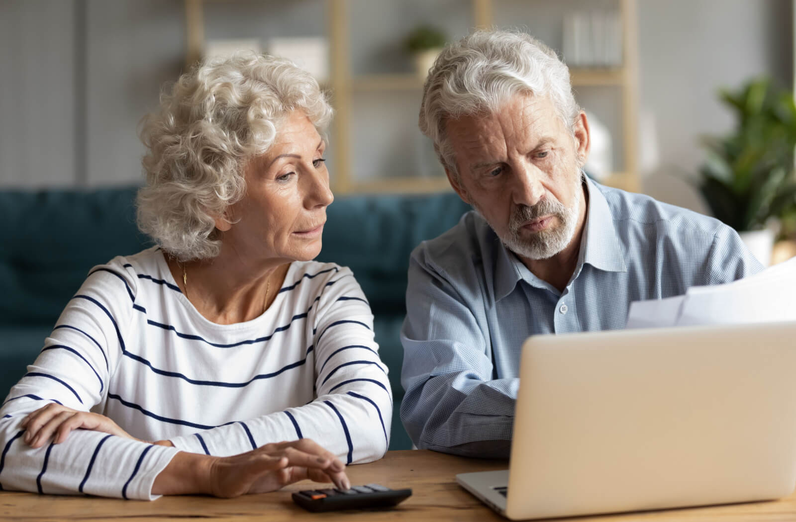 An older couple researching together to find a senior living community that offers both independent and assisted living.