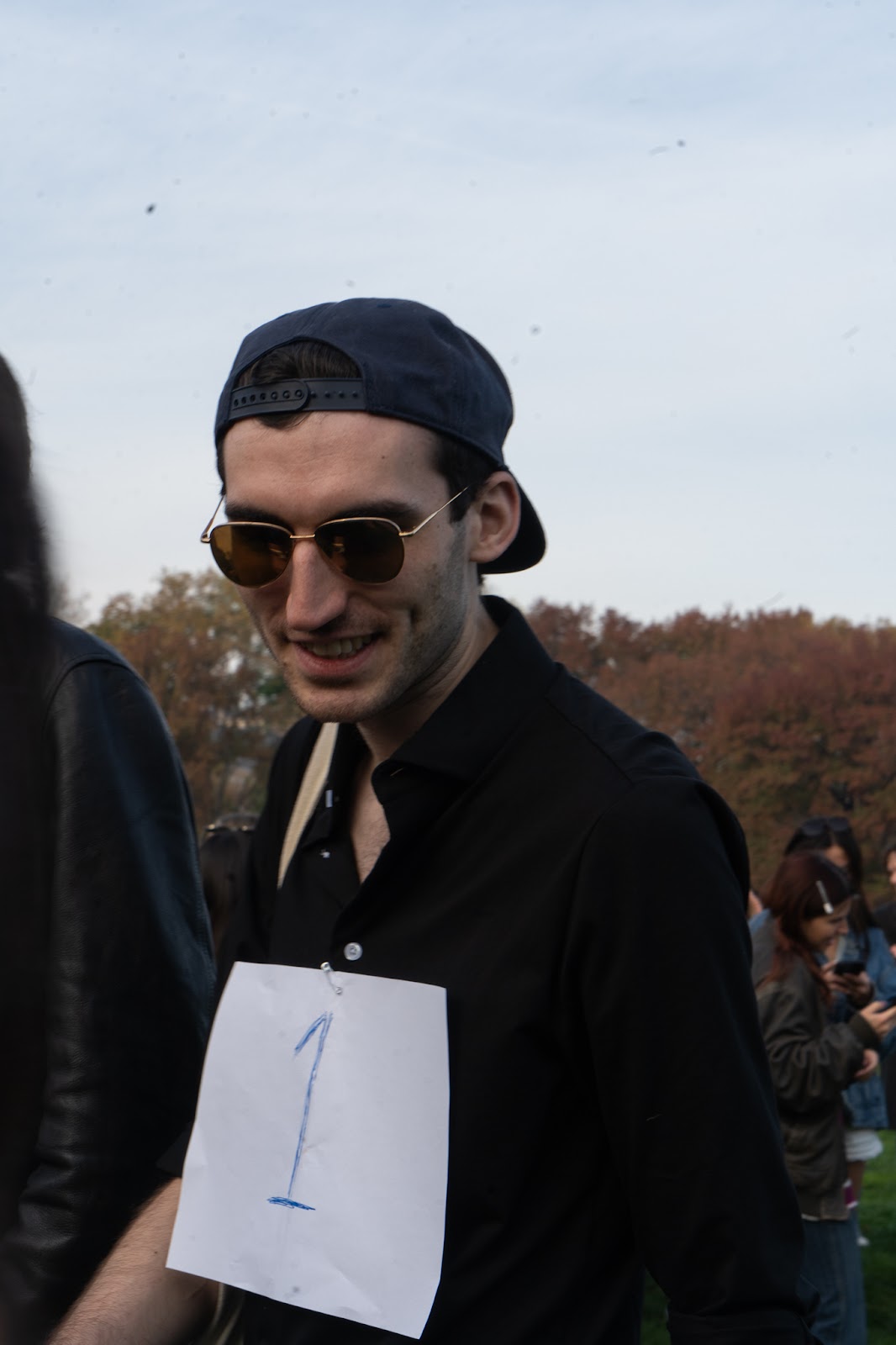 An image of the winner of the Jack Schlossberg look-alike contest, wearing his number card.