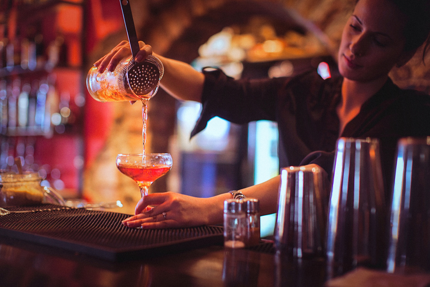 a bartender pouring a drink in The Last Tuesday Society Absinthe Bar
