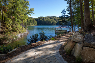 lake house ideas for your northern michigan home concrete pathway through foliage to waterfront custom built boyne city