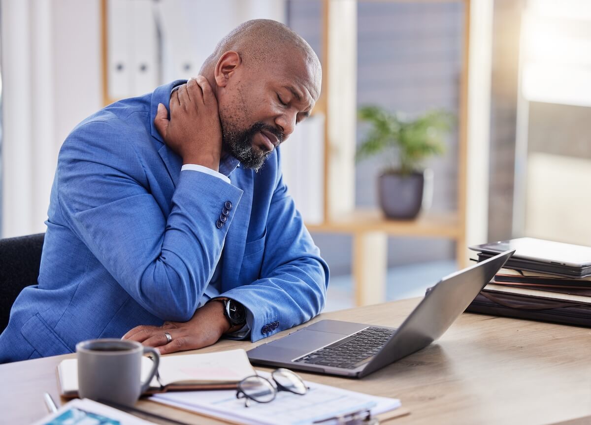 Work injury claims: tired entrepreneur touching his neck