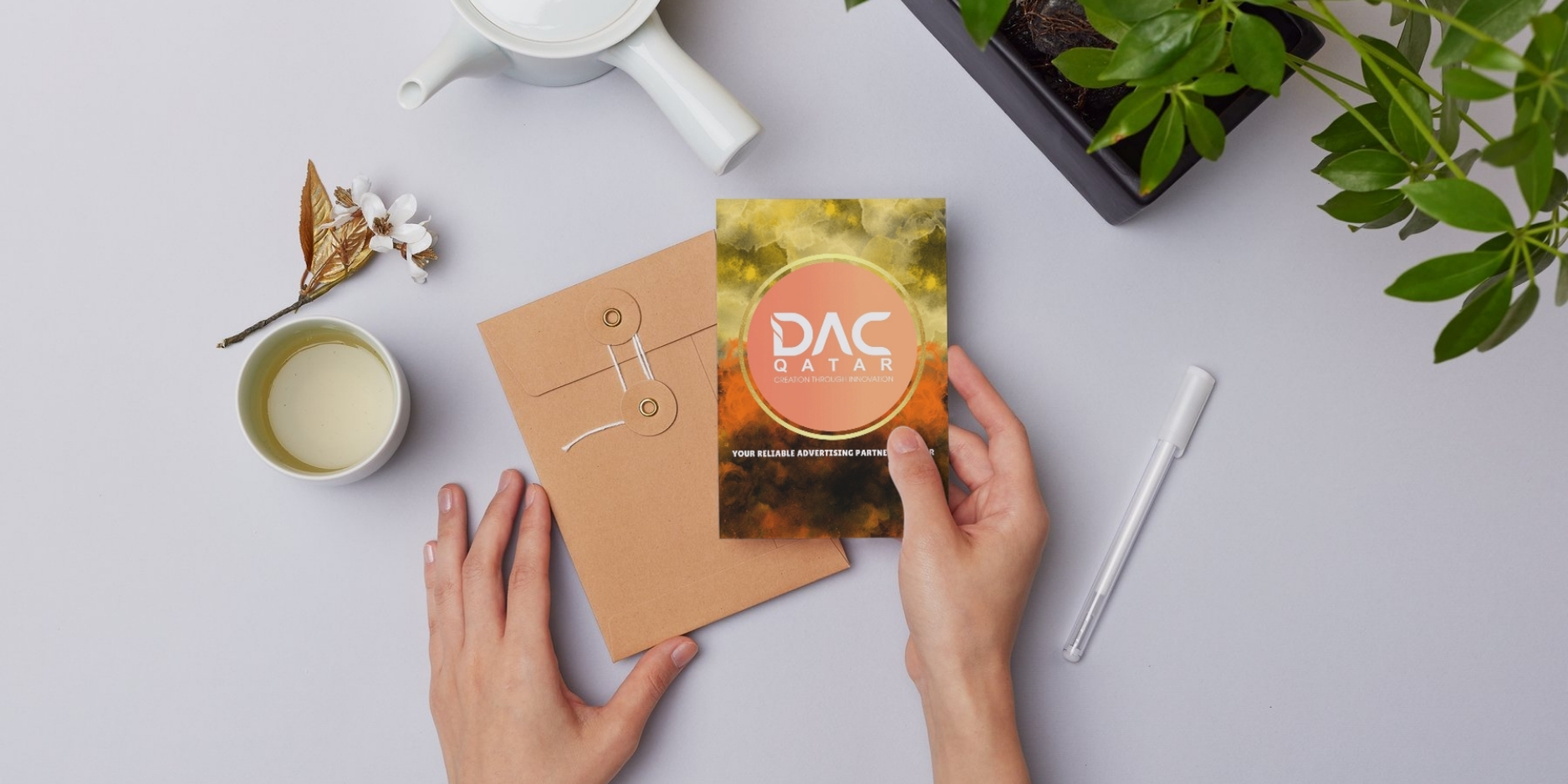 DAC Qatar – Your Trusted Digital Printing Partner in Qatar A person holding a professionally printed business card that highlights '10 years of excellence,' symbolizing premium digital printing quality.