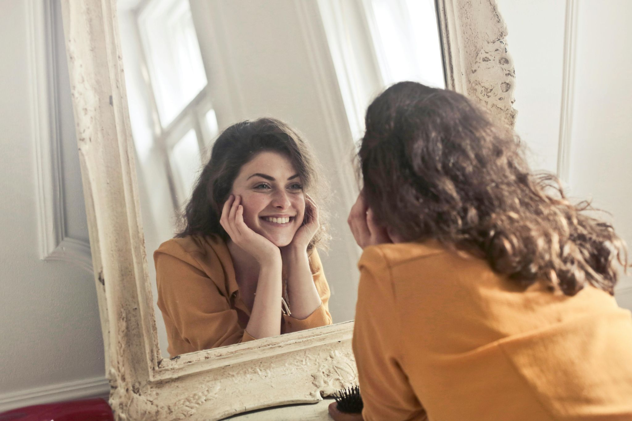 photo-of-woman-looking-at-the-mirror-