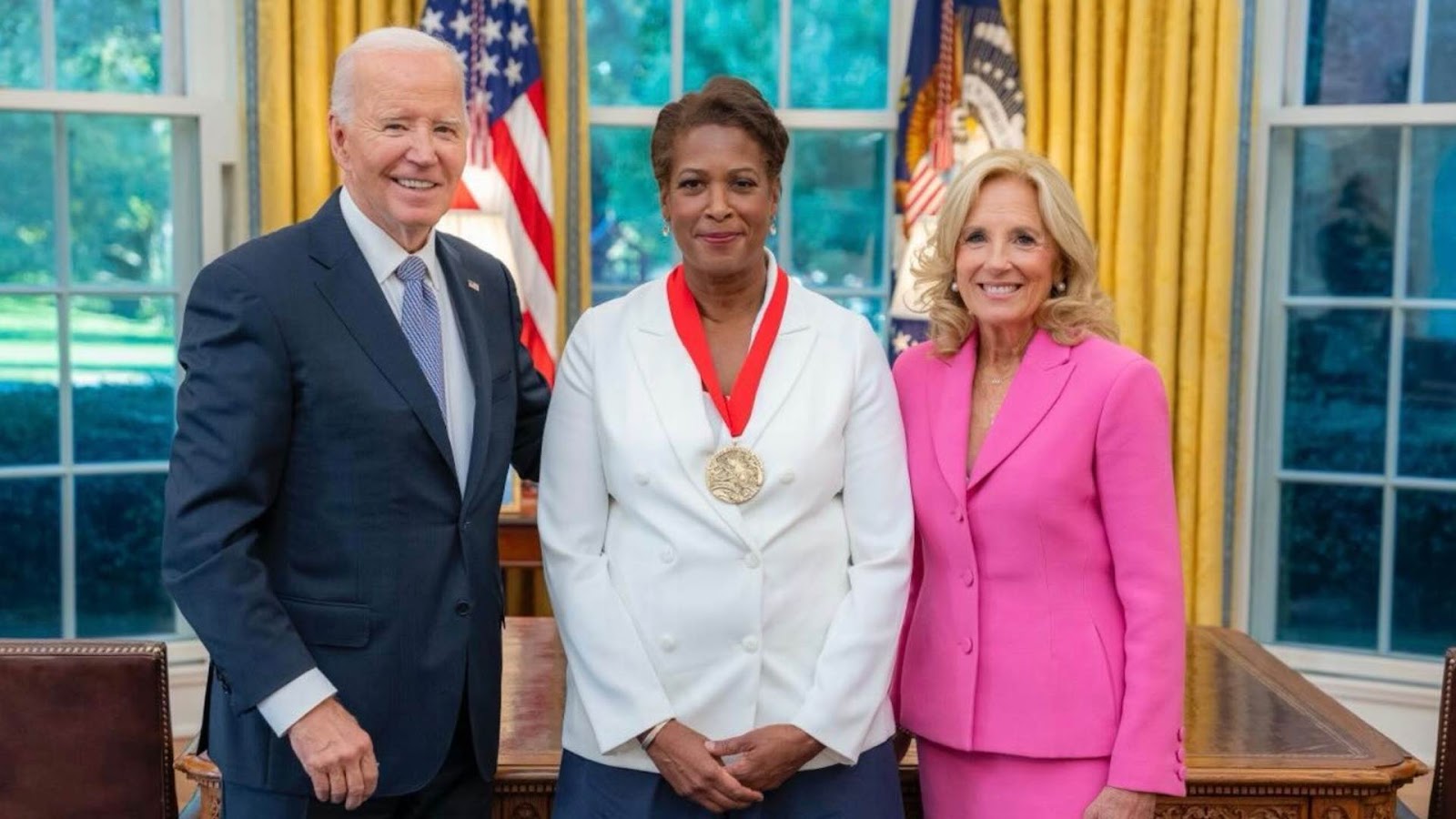 Image of Dawn Porter '88 recieveing the National Medal of arts  with President Joe Biden and First Lady Jill Biden