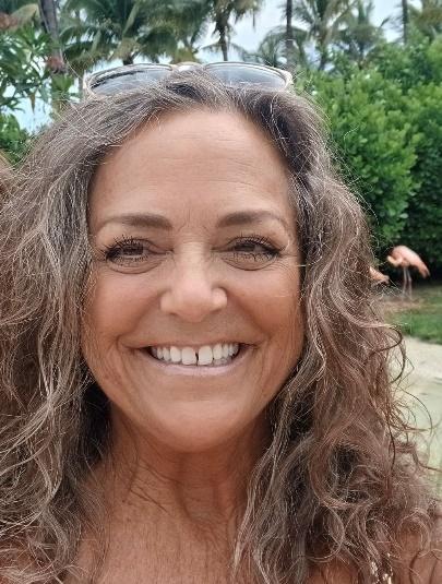 A person smiling for a picture Description automatically generated