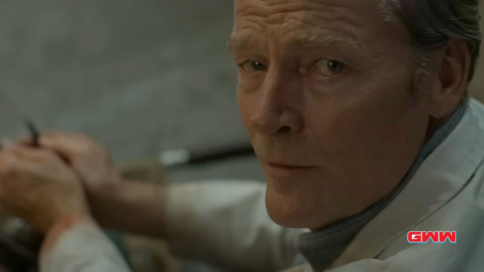 Iain Glen as Dr. Pete Nichols looks thoughtful while working in the silo's depths.