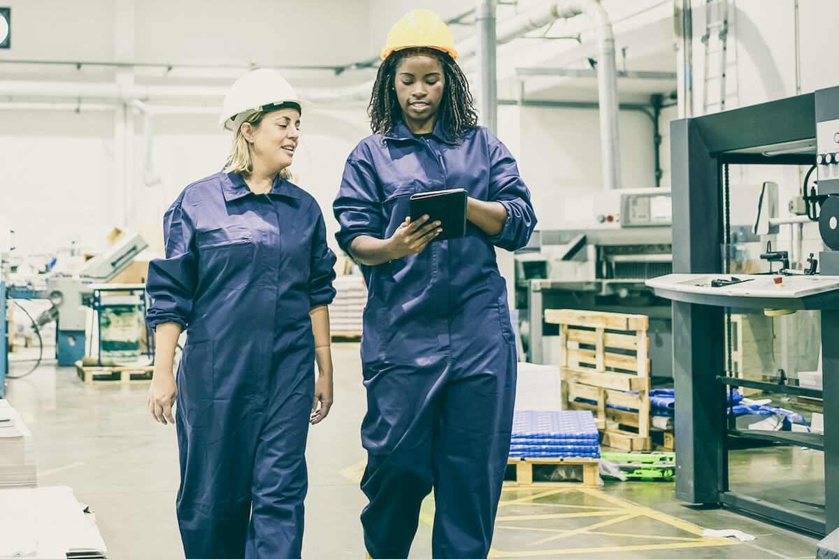 Workers looking at a tablet while walking