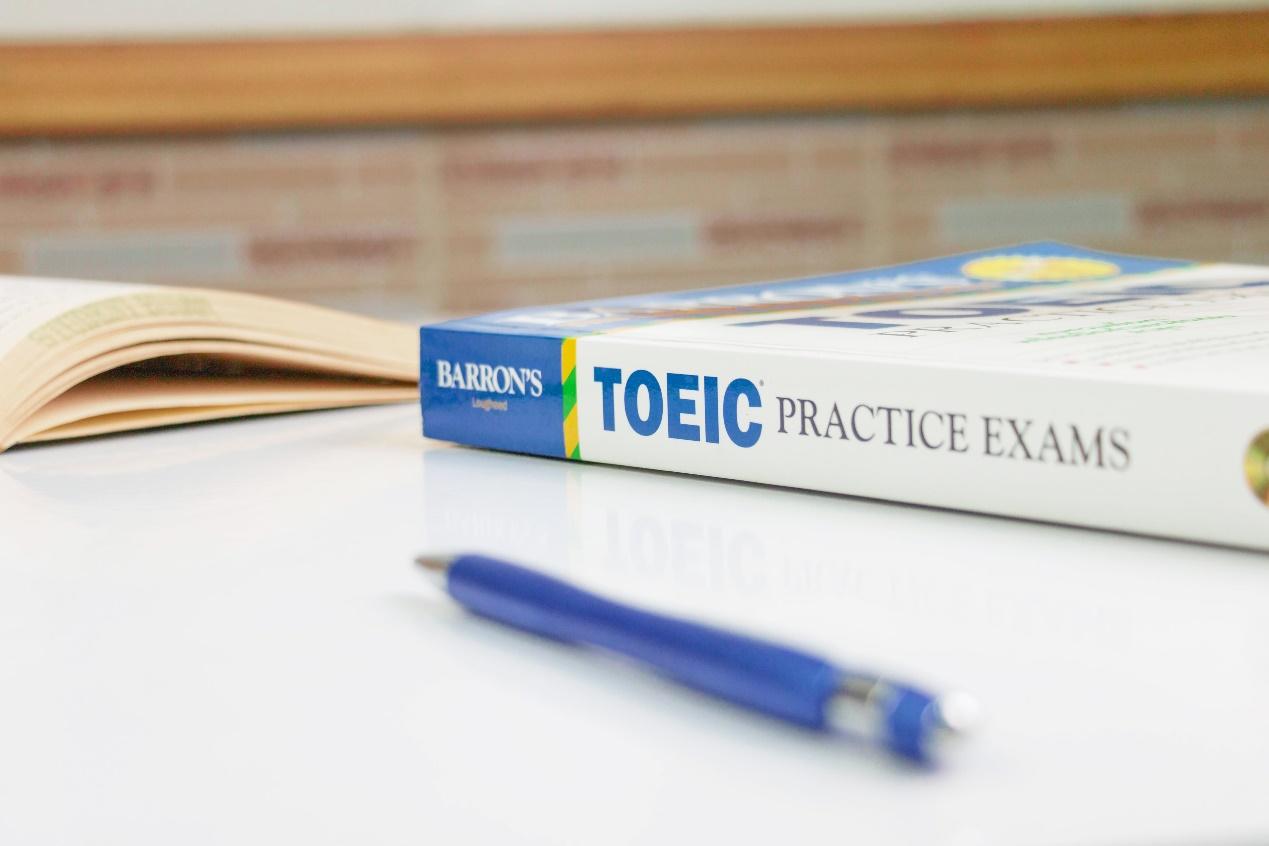 NAKHON RATCHASIMA, THAILAND- August 9, 2020: Barron's Toeic book on white table with textbook and pen in classroom