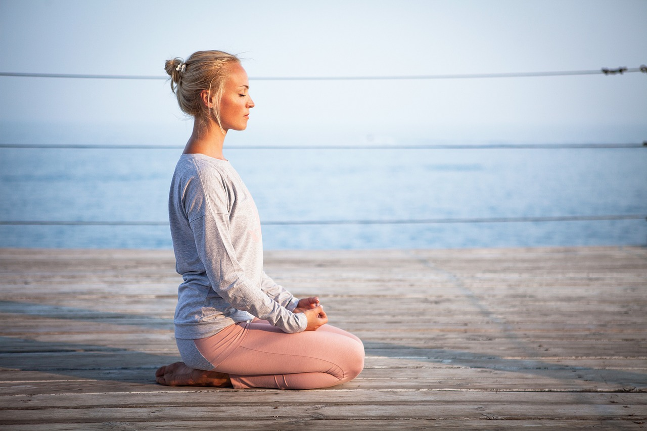 A woman doing meditation on a beach