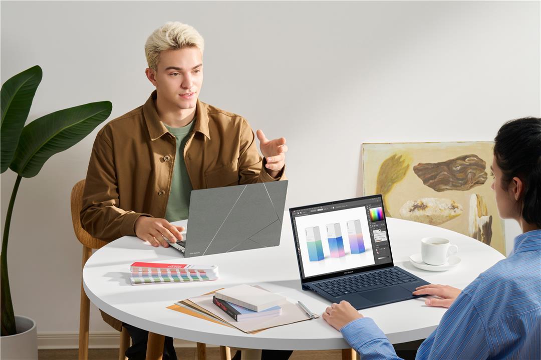 A group of people sitting at a table with a computer

Description automatically generated