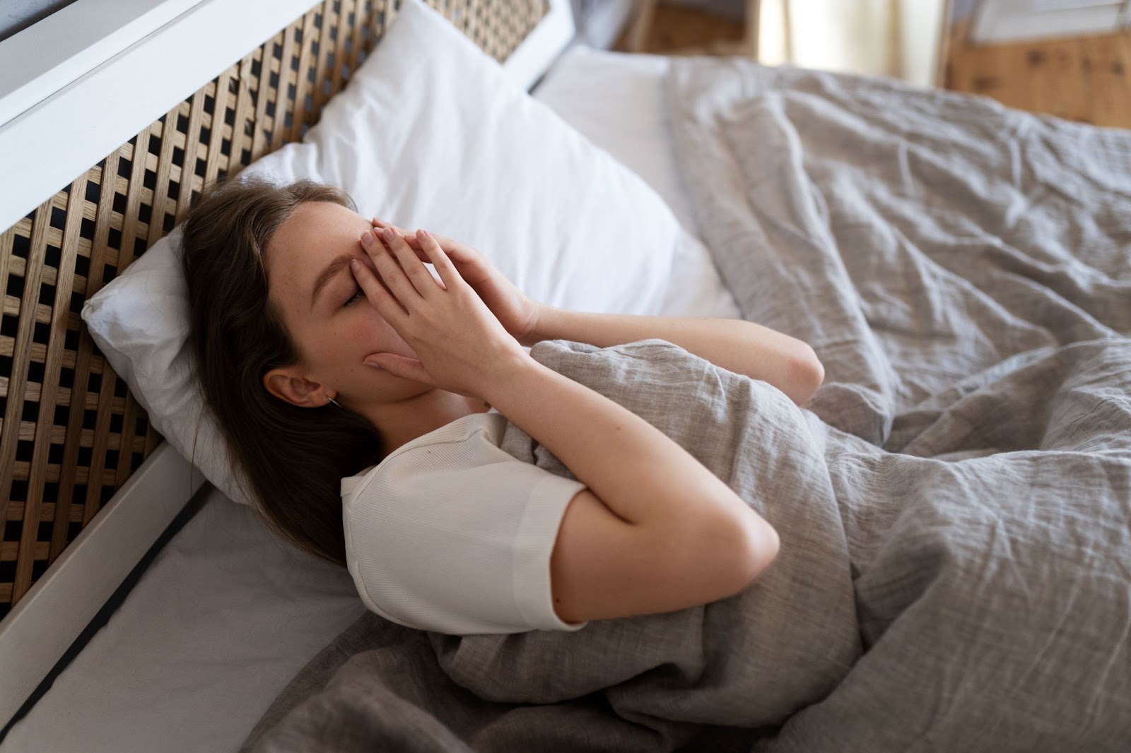 High angle anxious woman lying on her bed