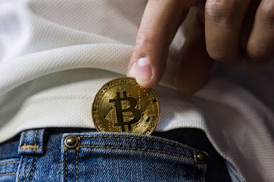  Gold Bitcoin Brough out of a Jean Pocket