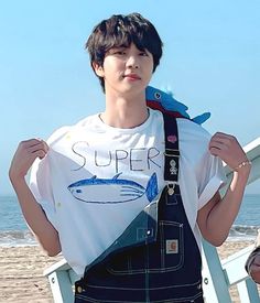 This contains an image of: Jin wearing the  "Super Tuna"  shirt 