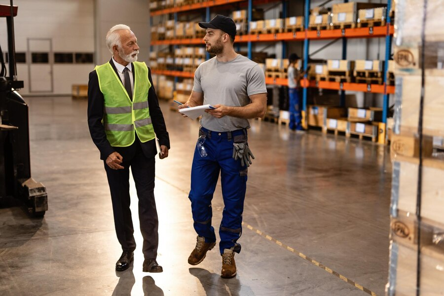 Warehouse manager reviewing cooling options with rep.
