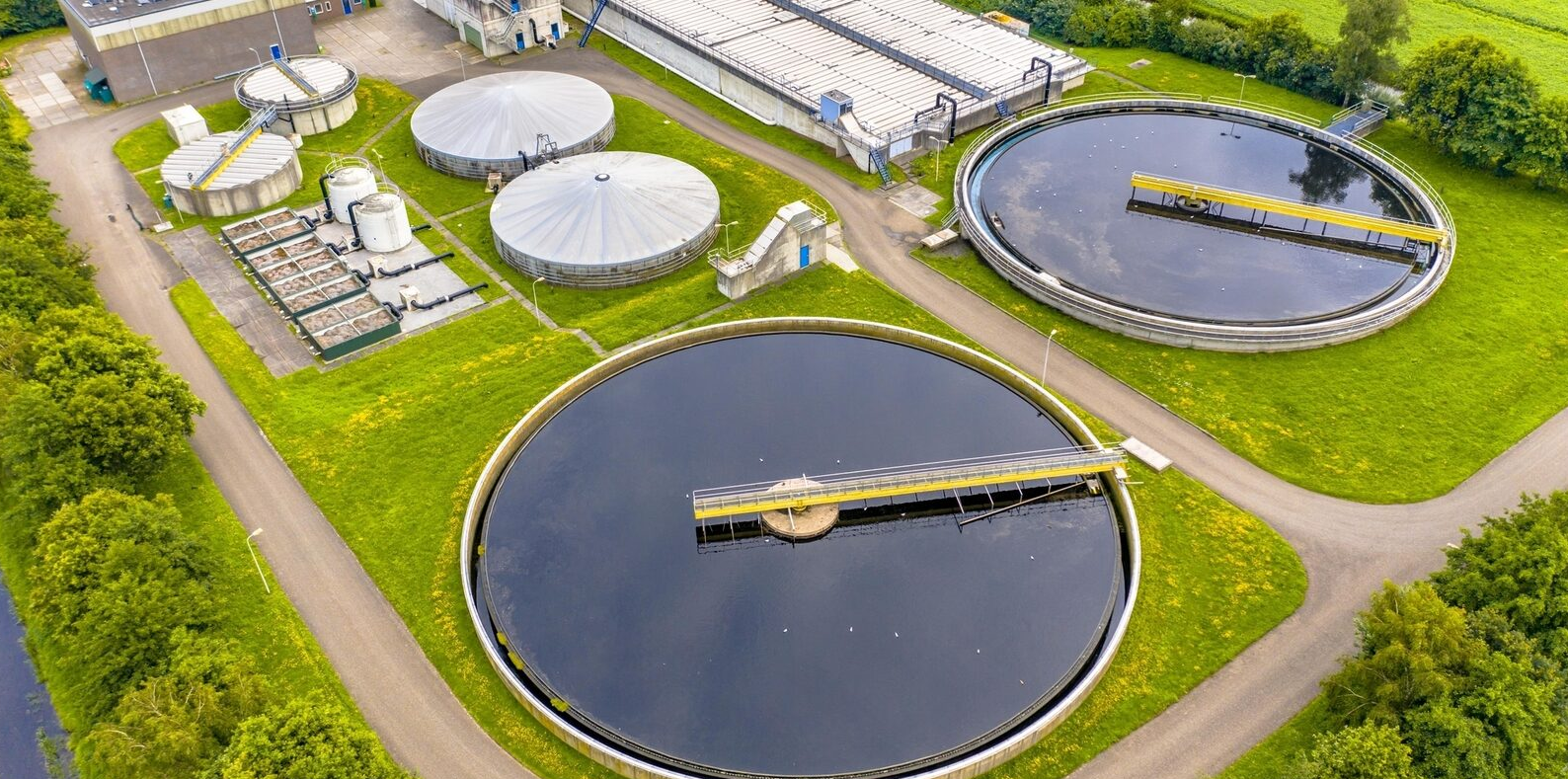 A large round tanks with a bridge over it

Description automatically generated with medium confidence