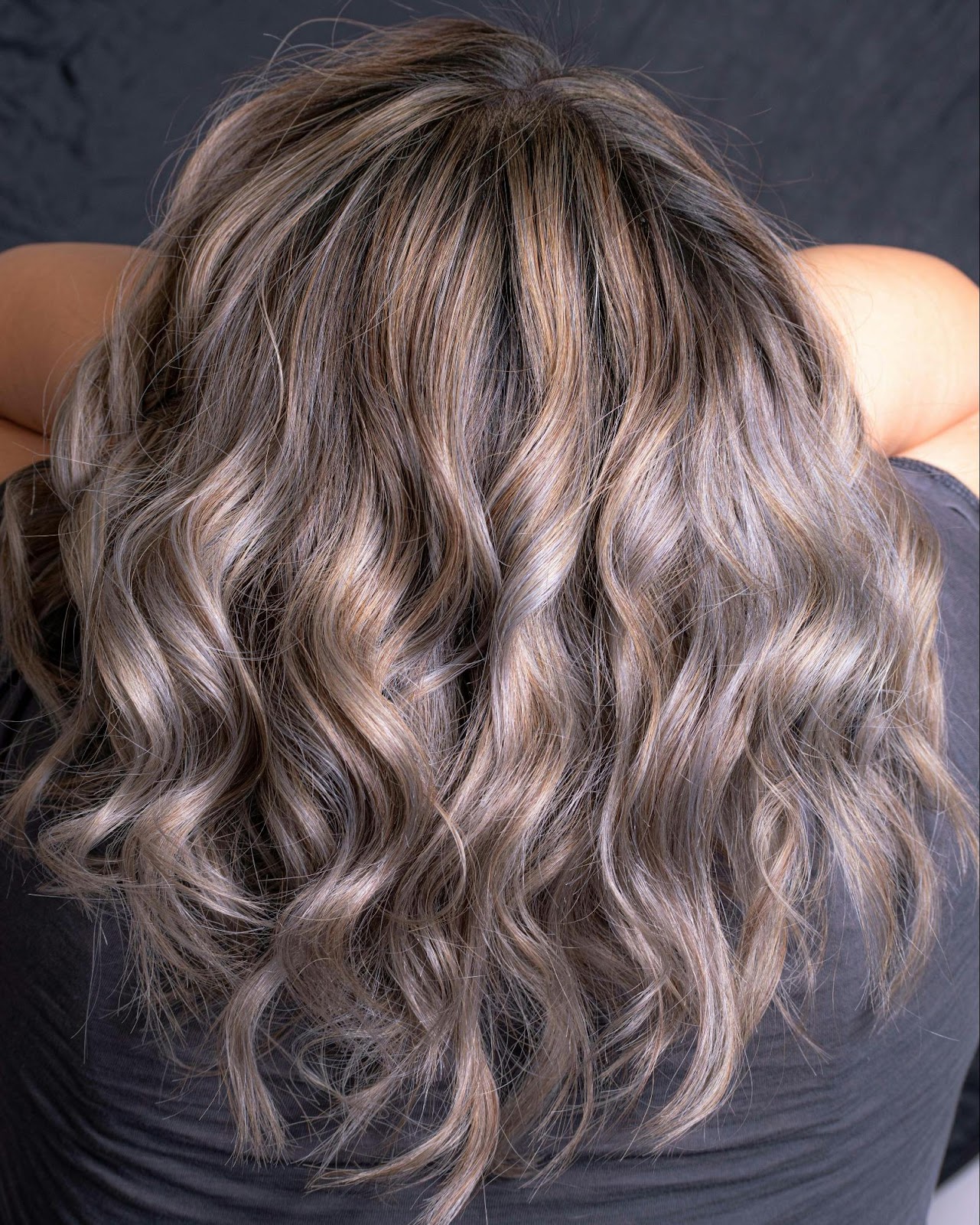 Back view of voluminous wavy hair with blended clip-in extensions