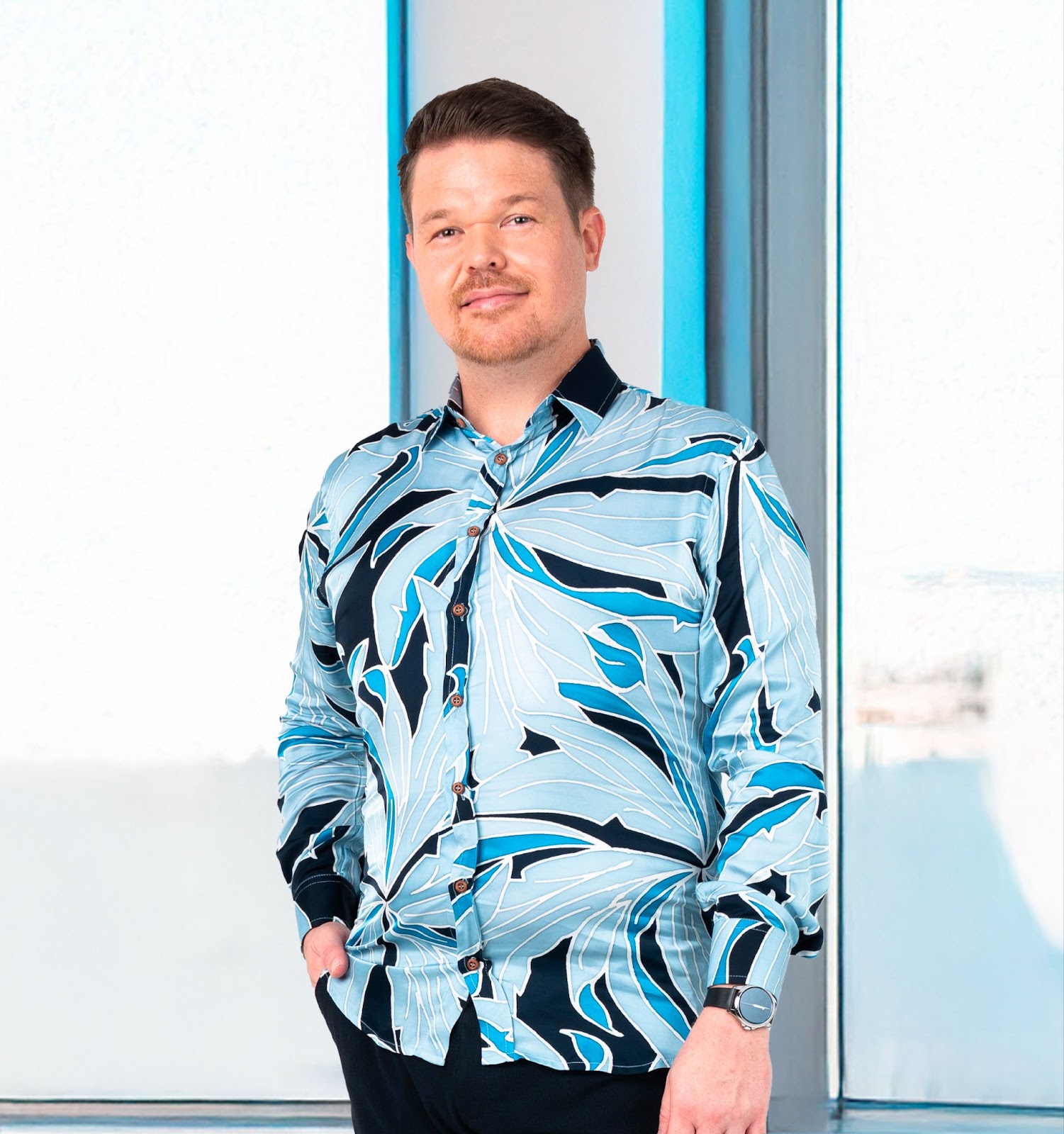 An image showing long sleeved men's batik shirt in moonlight palma from batik boutique, standing in a office