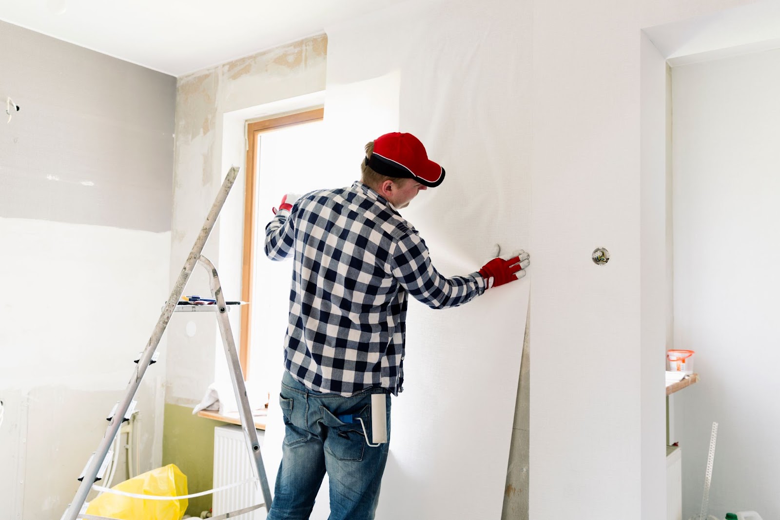 Professional hanging wallpaper on a wall