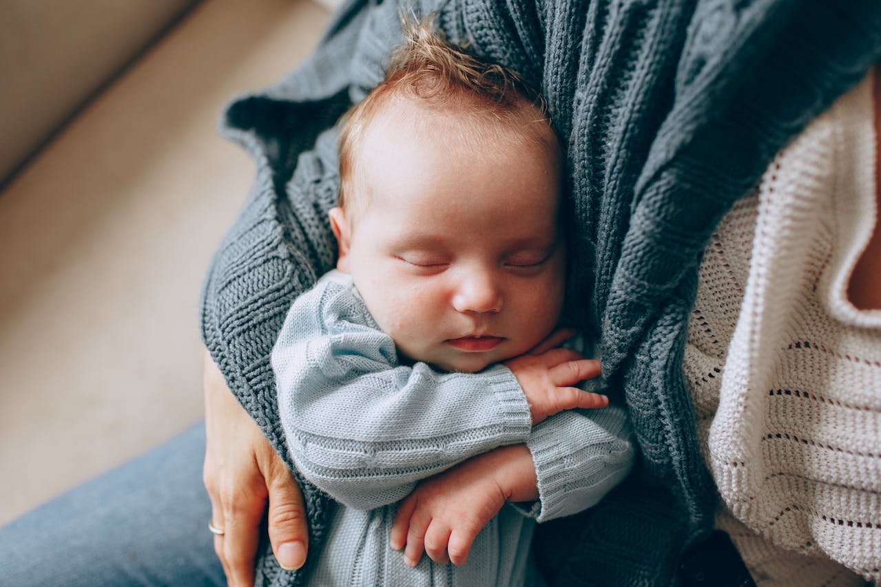 Mother Holding Sleeping Newborn // Healthier Baby Today