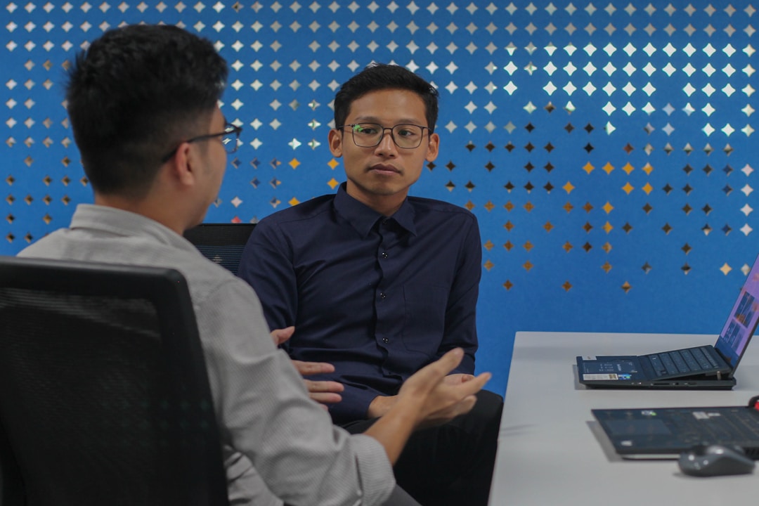 Two professional men discussing AI enablement and how AI enhances efficiency in business operations