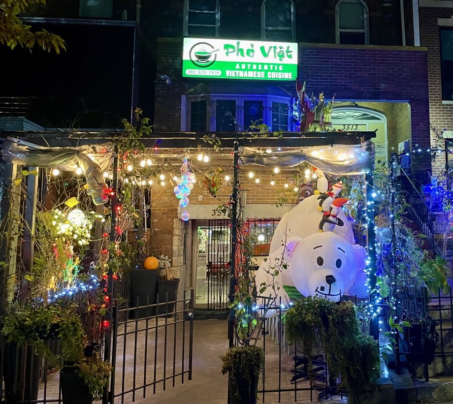 A view of Christmas lights and an inflatable polar bear in front of Pho Viet.